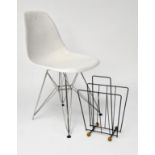 An Vitra Eames style chair of white plastic on a metal frame together with a magazine rack
