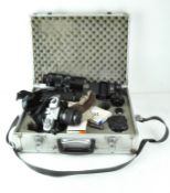 A vintage metal camera carry case contaiing cameras and equipment