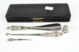 A cased three piece silver handled buttonhook, crochet hook and shoehorn set,