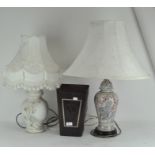 Two lamps and a leather bin, the lamps printed or moulded with flowers, with cream coloured shade,