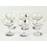 A set of six Babycham glasses, on circular bases, decorated with dancing deer,