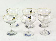 A set of six Babycham glasses, on circular bases, decorated with dancing deer,
