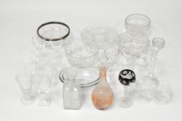 A collection of assorted glassware, including two decanters, a pair of candlesticks,