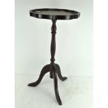 A small modern circular occasional table with scalloped edge and green leather inset,