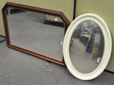 A large over mantel mirror, 72 cm x 104 cm, and an oval white painted example,