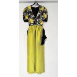 A vintage ladies evening dress with beaded top, black bow belt, and lime green full skirt,