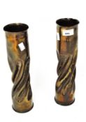 A pair of WWI trench art shell cases, modelled as vases and decorated with Regimental badges,
