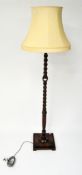 An early 20th century Oak barley twist standard lamp and shade,