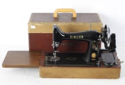 A vintage black and gilt Singer 99k hand crank sewing machine, model EN176901,