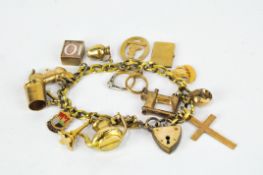 A vintage rolled gold charm bracelet, with heart locket, on which are numerous 9ct gold charms,