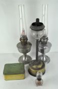 Three vintage oil lamps, one being a Super Aladdin, with glass funnel,