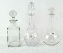Three 20th century glass decanters, one of square form, one cut glass, and one more,