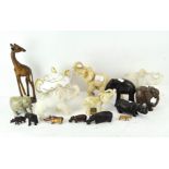 A quantity of elephant and hippo figures of various materials and sizes, and a giraffe,