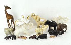 A quantity of elephant and hippo figures of various materials and sizes, and a giraffe,