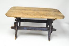 A vintage table with separate pine top with shaped corners,