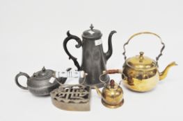 A selection of vintage pewter and brass teapots and kettles and an iron,