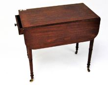 A Victorian mahogany pembroke table, raised upon turned supports, on original castors,