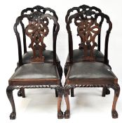 Four 20th century stained wood dining chairs with ornate back with a central knot motif,