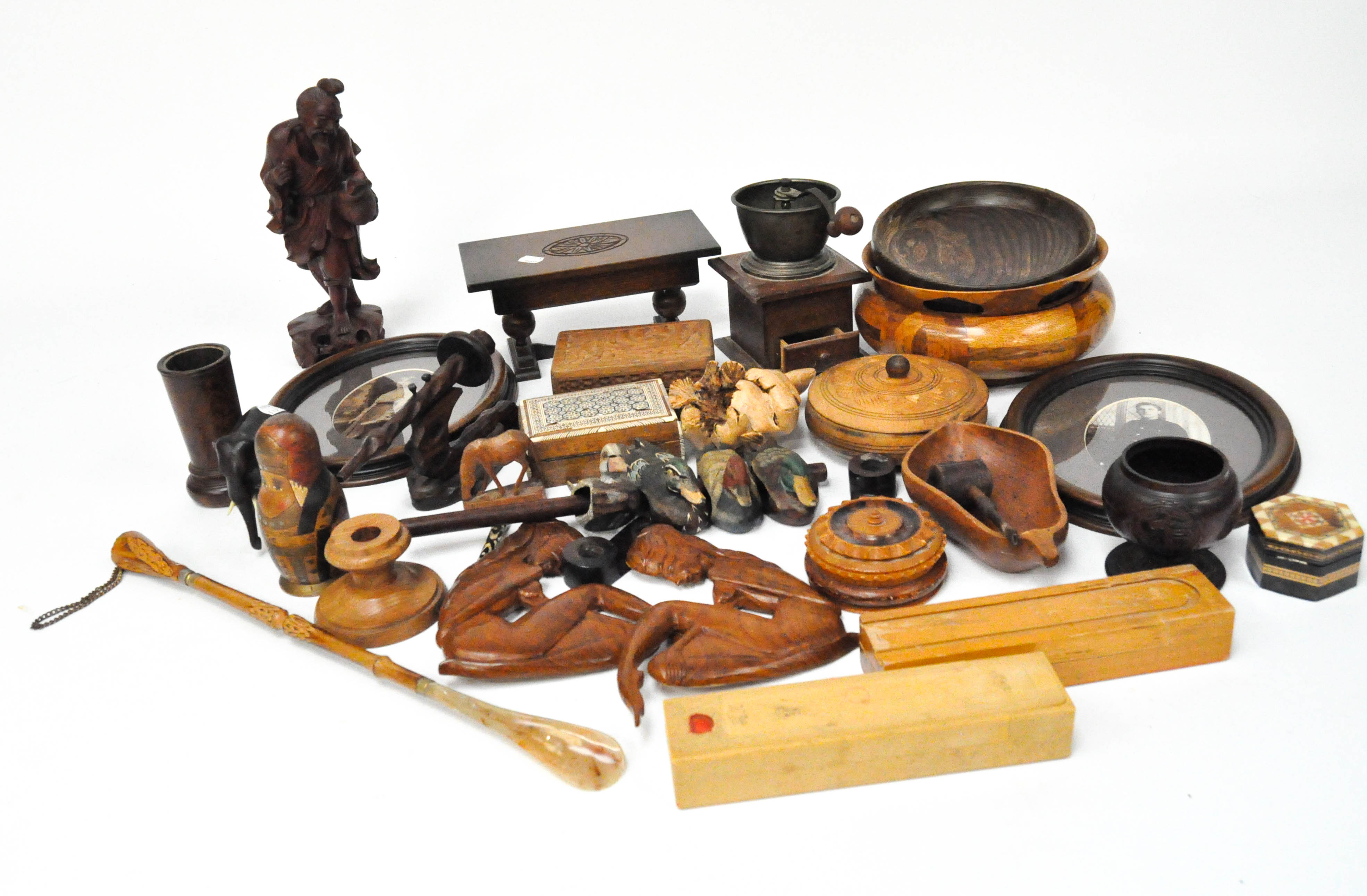 A large selection of woodenware, including treen, carved ebony elephant, Russian doll,