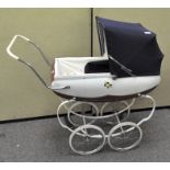 A mid-century doll's pram, with blue collapsible hood and metal body,