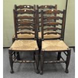 A set of four 19th century elm ladder back chairs with rush seats and turned legs on bun feet,