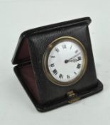 A early 20th century travelling clock, white dial with Roman numerals, diameter 6cm,