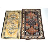 Two rugs, one of Chinese design with blue and white scroll pattern on a yellow ground,150cm x 95cm,