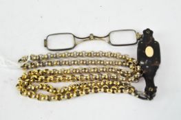 An early 20th century tortoiseshell lorgnette, clip action clasp,