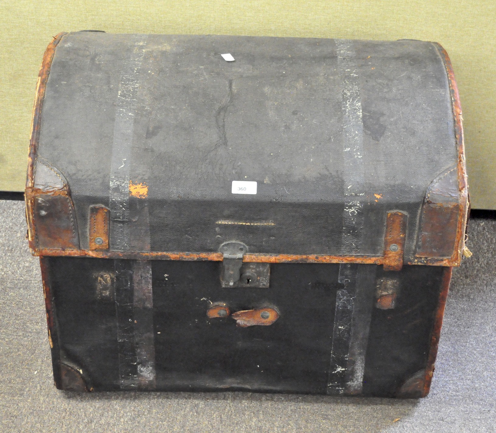 An early 20th century black painted dome top trunk,