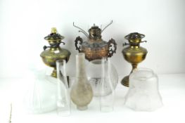 Three 20th Century oil lamps, two brass and one copper example,