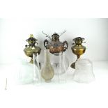 Three 20th Century oil lamps, two brass and one copper example,