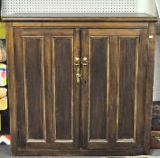 A large stained pine kitchen storage unit, the two cupboard doors opening to reveal three shelves,