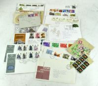 A selection of stamped envelopes and loose stamps,