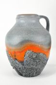 A West German pottery jug, with raised decoration,