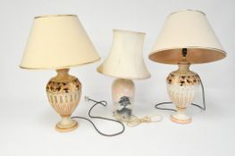 A pair of ceramic table lamps with cream shades, height 70cm, together with another