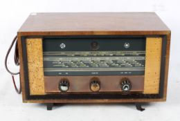 A Cambridge PYE AM/FM tuner, type htf111, within a wooden case on raised feet,