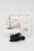 A modern Singer Tradition electric sewing machine with tredel,