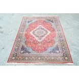 A Wilton Beshir carpet in shades of red, duck-egg blue and navy blue,