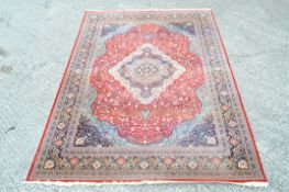 A Wilton Beshir carpet in shades of red, duck-egg blue and navy blue,
