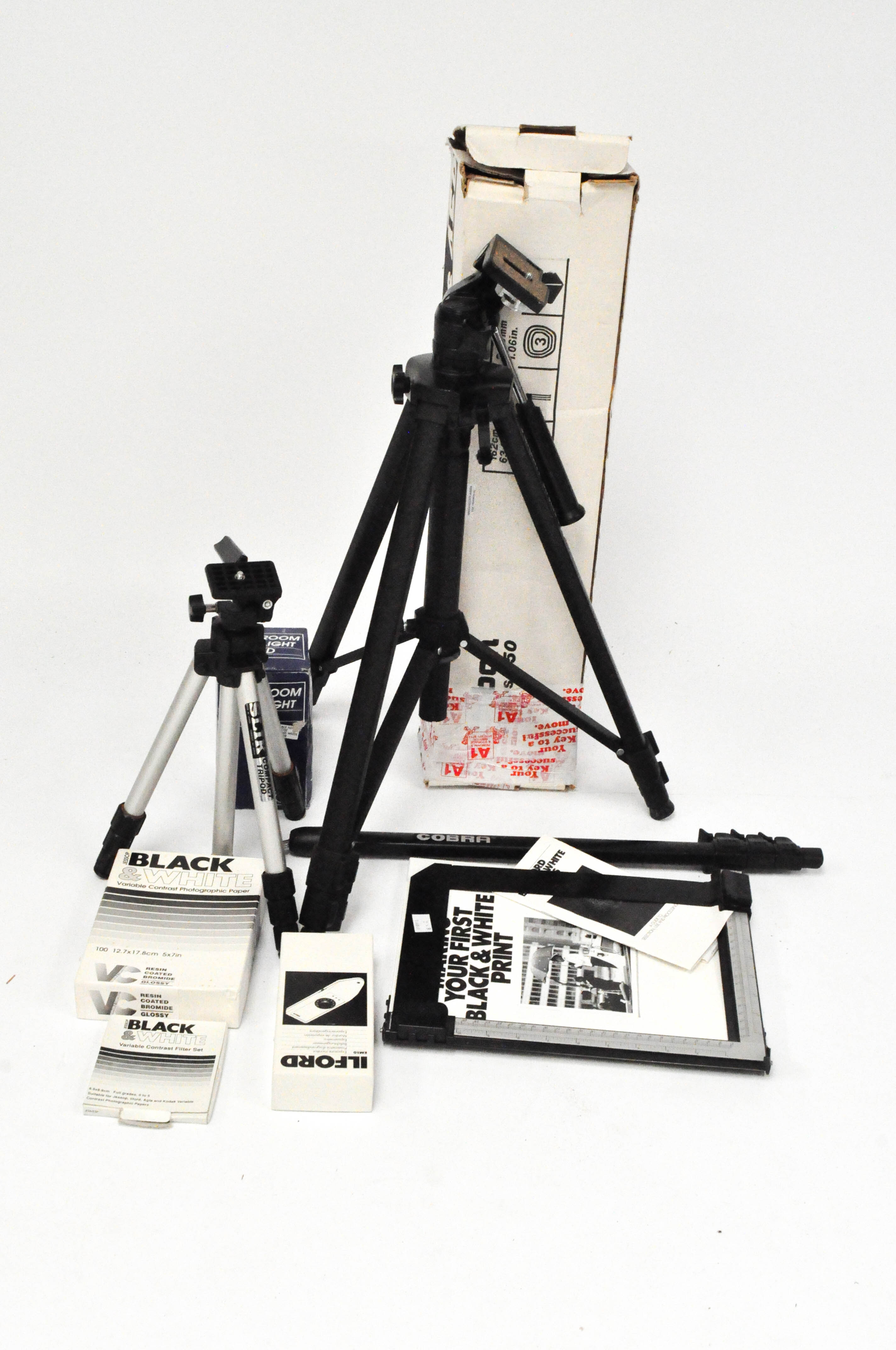 A group of camera accessories including a Slik tripod, a Jessop darkroom safelight red,