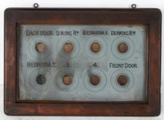 A butler/servants wall mounted bell box, in mahogany case with 8 windows each with flags behind,