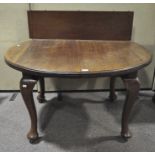 An oval mahogany dining table, on wheels, supported on four cabriole feet, with extra leaf,