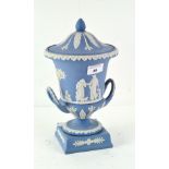 A Wedgwood Jasperware two handled urn and cover, in blue and white,