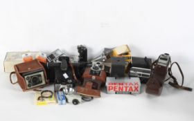 A box of vintage cameras, including a Kodak Brownie, Model D, a Kodak Bantam, an Instamatic 300,