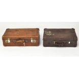 A group of four vintage leather suitcases, one being a large example form Shanghai,