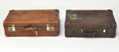 A group of four vintage leather suitcases, one being a large example form Shanghai,