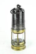 A metal and brass fitted miners lamp, British made, indistinctly stamped 'Guy',