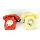 Two vintage telephones, in red and cream cases,