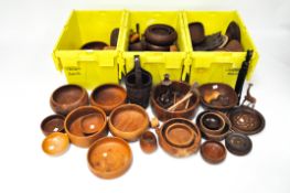 A large selection of turned wooden bowls, of assorted shapes and sizes and in a variety of woods,