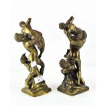 A pair of cast brass sculptures, featuring figures in dramatic poses,